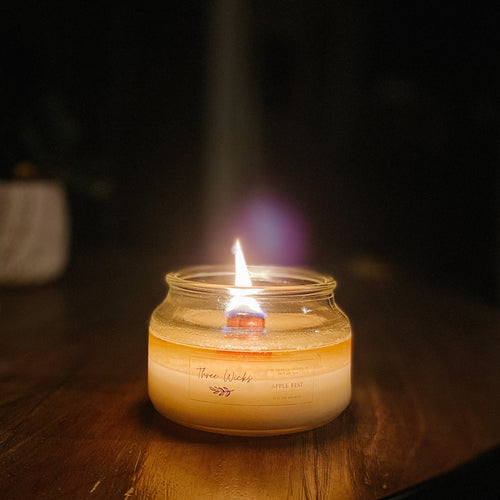 Wood wick candle burning at night