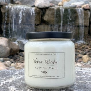Scented candle made with soy with a wood wick is scented in Happy Fall Y'All and is in a 16 oz vessel